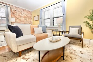 Relax in a stylish living space with a sofa, armchair, and coffee table.