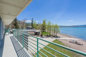 Enjoy breathtaking views of the lake from this serene lakeside retreat's spacious balcony.