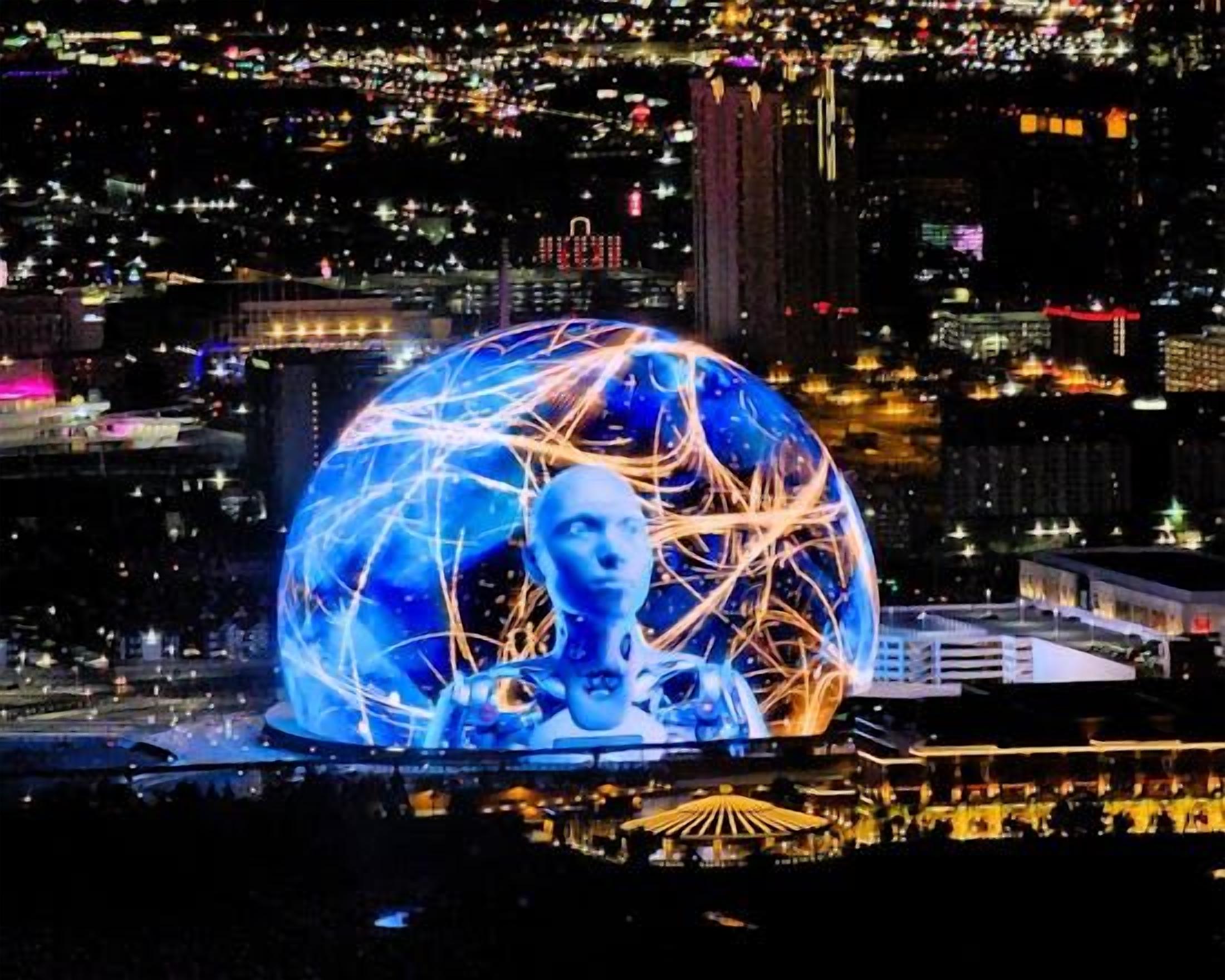 Una estructura esfèrica amb línies il·luminades, situada davant d'un paisatge urbà de nit.