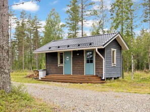 A small cabin with a porch, surrounded by trees. - Lonnakko by Interhome (Kittilä)