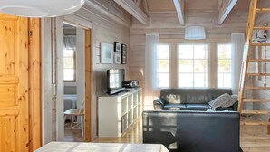 A cozy cabin interior with a bed, a sofa, a TV, and a ladder. - Lonnakko by Interhome (Kittilä)