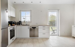 Fridge, stovetop, dishwasher, coffee/tea maker