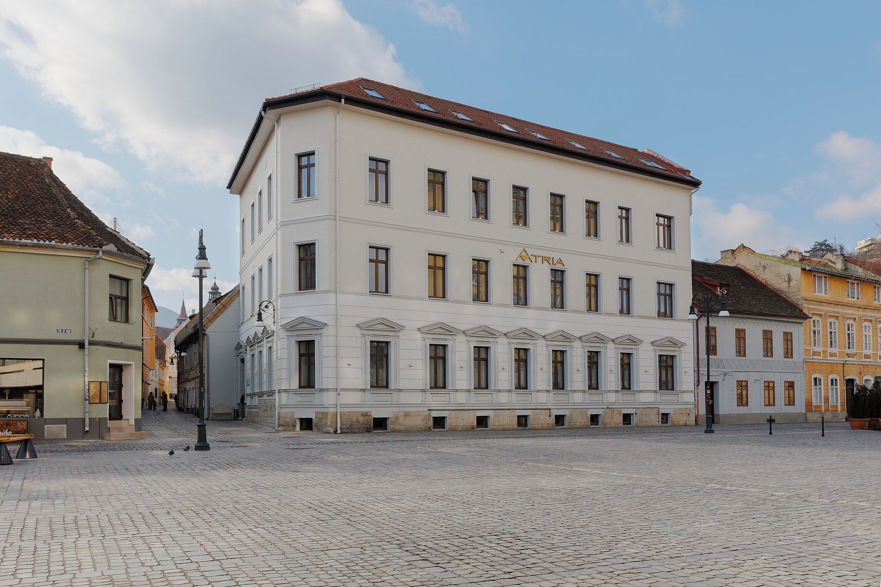 A historic building with a symmetrical facade, multiple windows, and a central entrance.