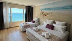 A hotel room with two beds, a large window with a view of the sea, and a beach-themed mural on the wall. - Hotel Britania  (Vlorë)