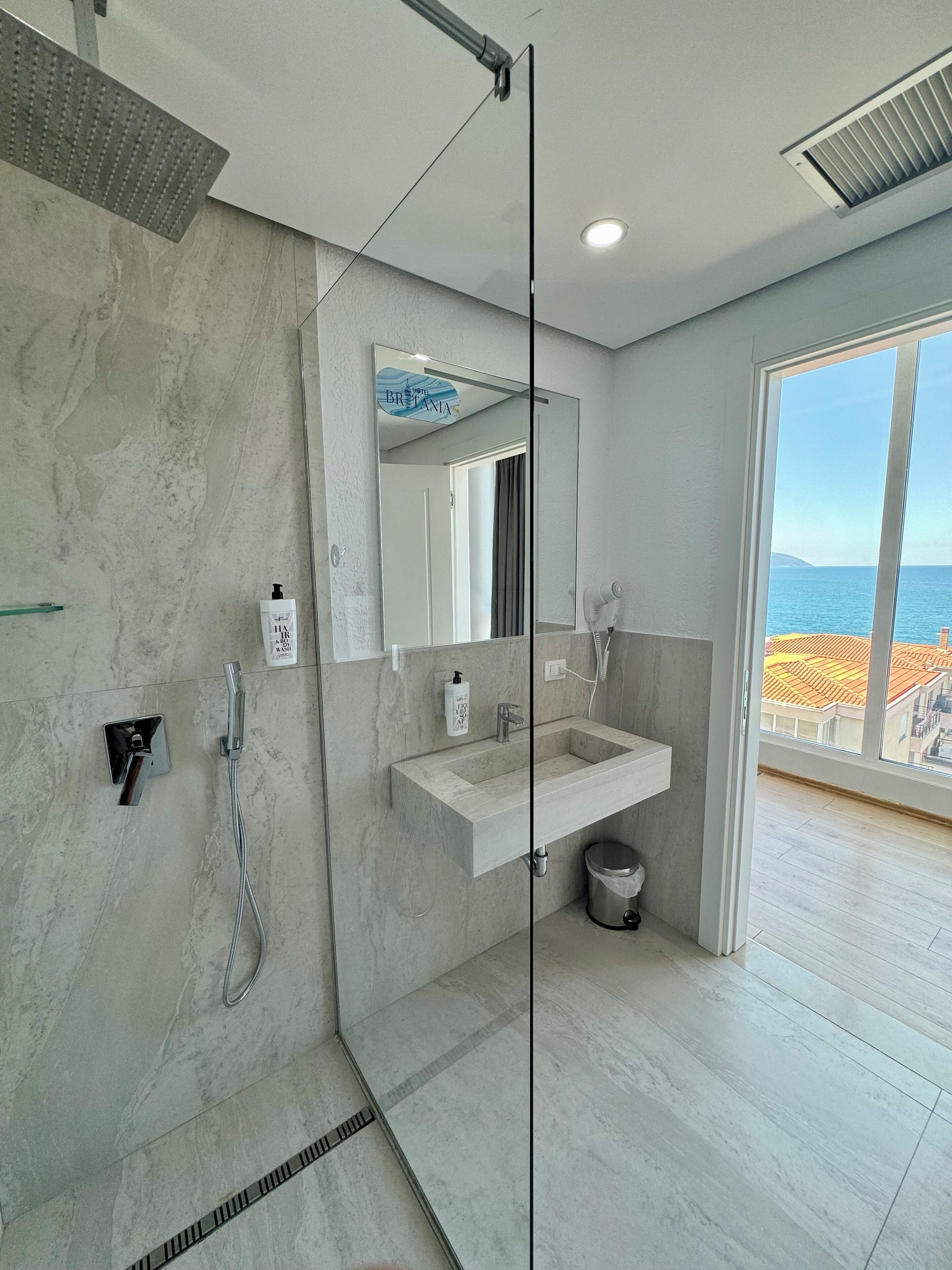 Shower, hair dryer, slippers, towels