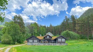 A cabin with a stone foundation, multiple rooms, and a mountain backdrop. - Nice home in Folkestad with sauna (Folkestad)