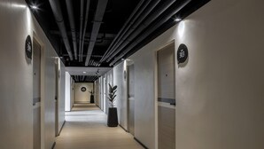 A hallway with doors numbered 302 and 304, leading to rooms. - BedTime Hotel Samui (Koh Samui)