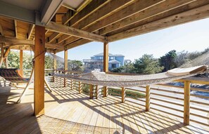 A wooden deck with a hammock and a wooden pergola structure. - Downtown Duck! Resort Perks, Ocean Views & Hot Tub (Duck)