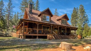 A rustic log cabin with a porch, a chimney, and a deck. - 3C Ranch on the Road to Yosemite (Groveland)