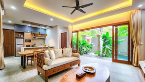 A modern living room with a sofa, coffee table, and a TV.