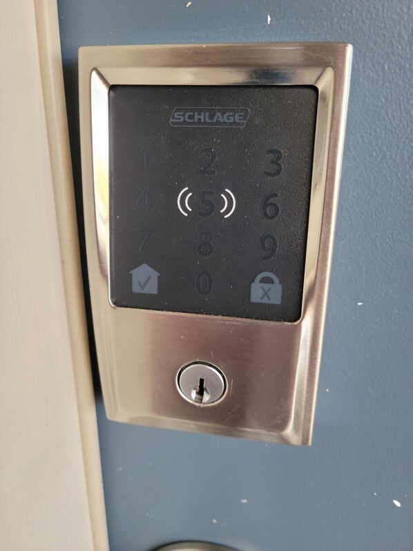 A SCHLAGE electronic keypad lock on a door.
