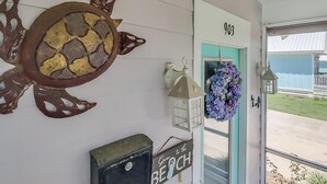 A door with the number 903, a turtle decoration, a lantern, and a sign that says "Gone to the Beach". - Parrothead Escape-3BD/2BA- 1 block from beach - Pet Friendly (Gulfport)