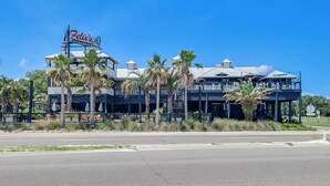 A two-story building with a sign reading "Felix's." - Parrothead Escape-3BD/2BA- 1 block from beach - Pet Friendly (Gulfport)