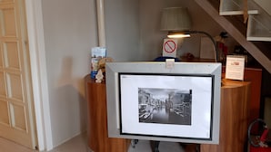 A framed black and white photograph of a canal scene, a lamp, and a sign with a prohibition symbol. - Adam Venice 1 (Mira)