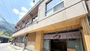 A guesthouse with a sign indicating a 70m parking area.