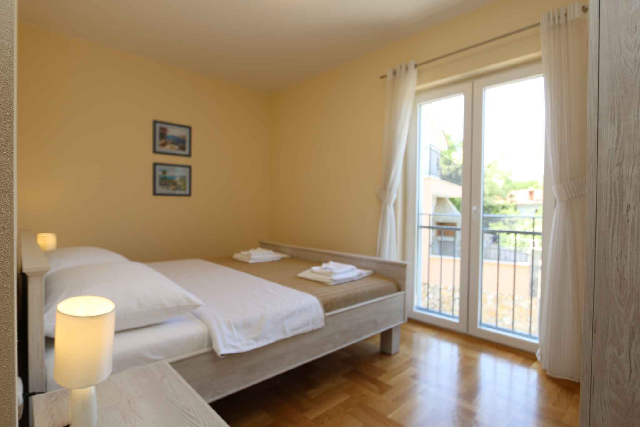 Une chambre d’hôtel avec un lit, une lampe de chevet et une vue sur l’extérieur grâce à une porte-fenêtre coulissante.