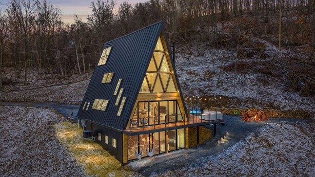 A modern house with a triangular roof, large windows, and a wooden deck. - Ava A-Frame•Hot Tub•Theater•Hidden Stair•EV Charge (Stanley)