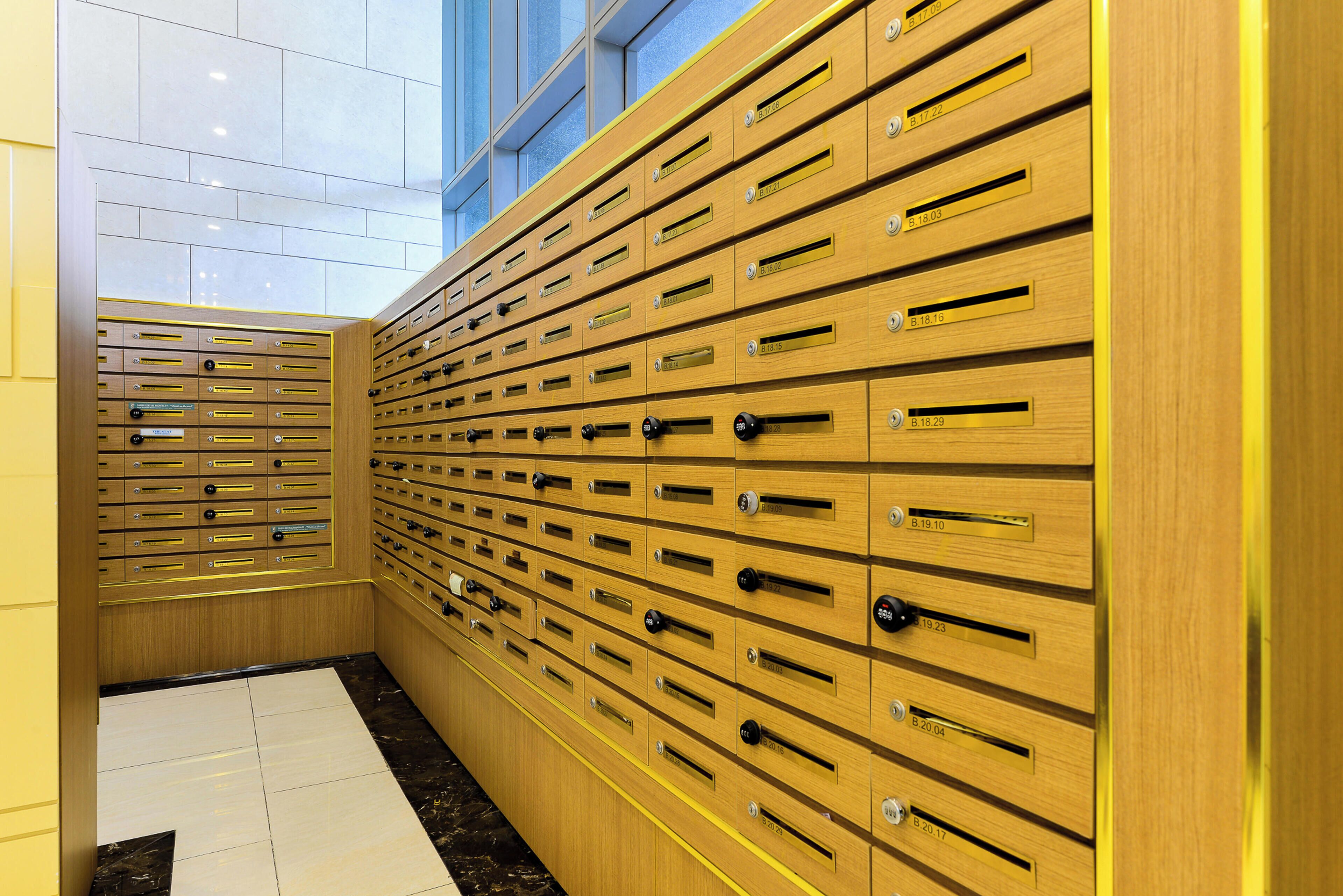 A row of wooden lockers with metal handles and numbered labels.