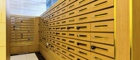 A row of wooden lockers with metal handles and numbered labels.