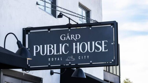 Et skilt for 'GARD Public House' med et simpelt, elegant design.
