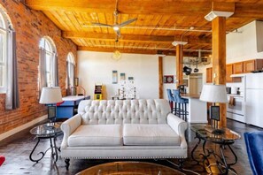 TV, fireplace, books - Fun Loft with Arcade Games and River Views (Detroit)