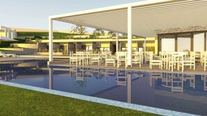 A modern outdoor pool area with a covered seating area and a stone facade building. - Elegance Resort Rhodos (Adults Only)  (Rhodes)