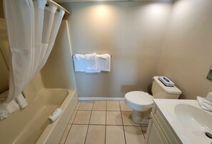 A bathroom with a bathtub, toilet, and sink. - Water's Edge Ocean Resort (Wildwood Crest)