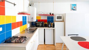 A compact kitchen with a gas stove, microwave, and small refrigerator. - Apartment 'Residence Le Sabaou' with Balcony (Biarritz)