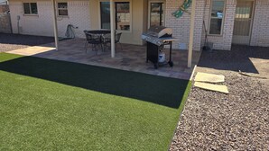 A house with a patio, a grill, and a butterfly decoration. - Clean, Comfortable Home Away From Home! (El Paso)
