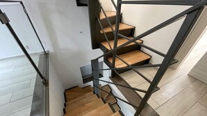 A modern staircase with wooden steps and a metal frame. - Crispi Penthouse at historic center with panoramic terrace  (Catania)
