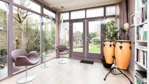 A room with large windows, a drum set, two chairs, and a bookshelf. - Lovely home in Sneek with WiFi (Sneek)