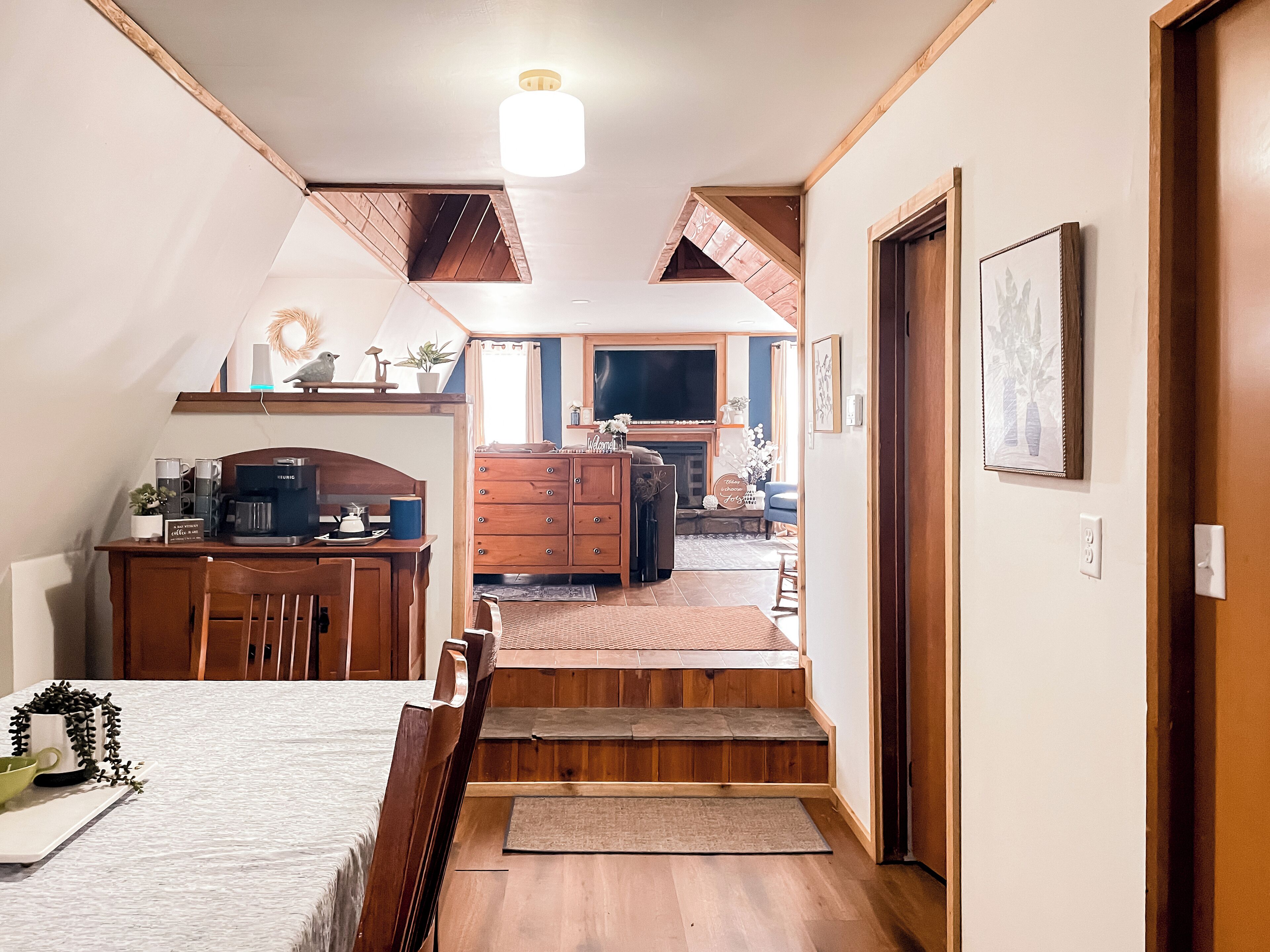 A cozy, well-lit room with a dining area, a kitchen, and a living space.