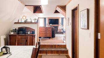 A cozy, well-lit room with a dining area, a kitchen, and a living space.