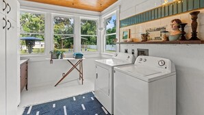 A laundry room with a wooden ceiling, large windows, and a sink. - Quiet Historic Family Retreat with Pool--Pet Friendly--No Events (Bushnell)