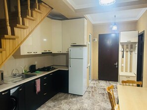 Room, City View | Private kitchen | Stovetop, cleaning supplies, freezer