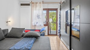 A modern bedroom with a sofa bed, a balcony with a view, and a large window with curtains. - 3 bedroom lovely apartment in Vodice (Vodice)