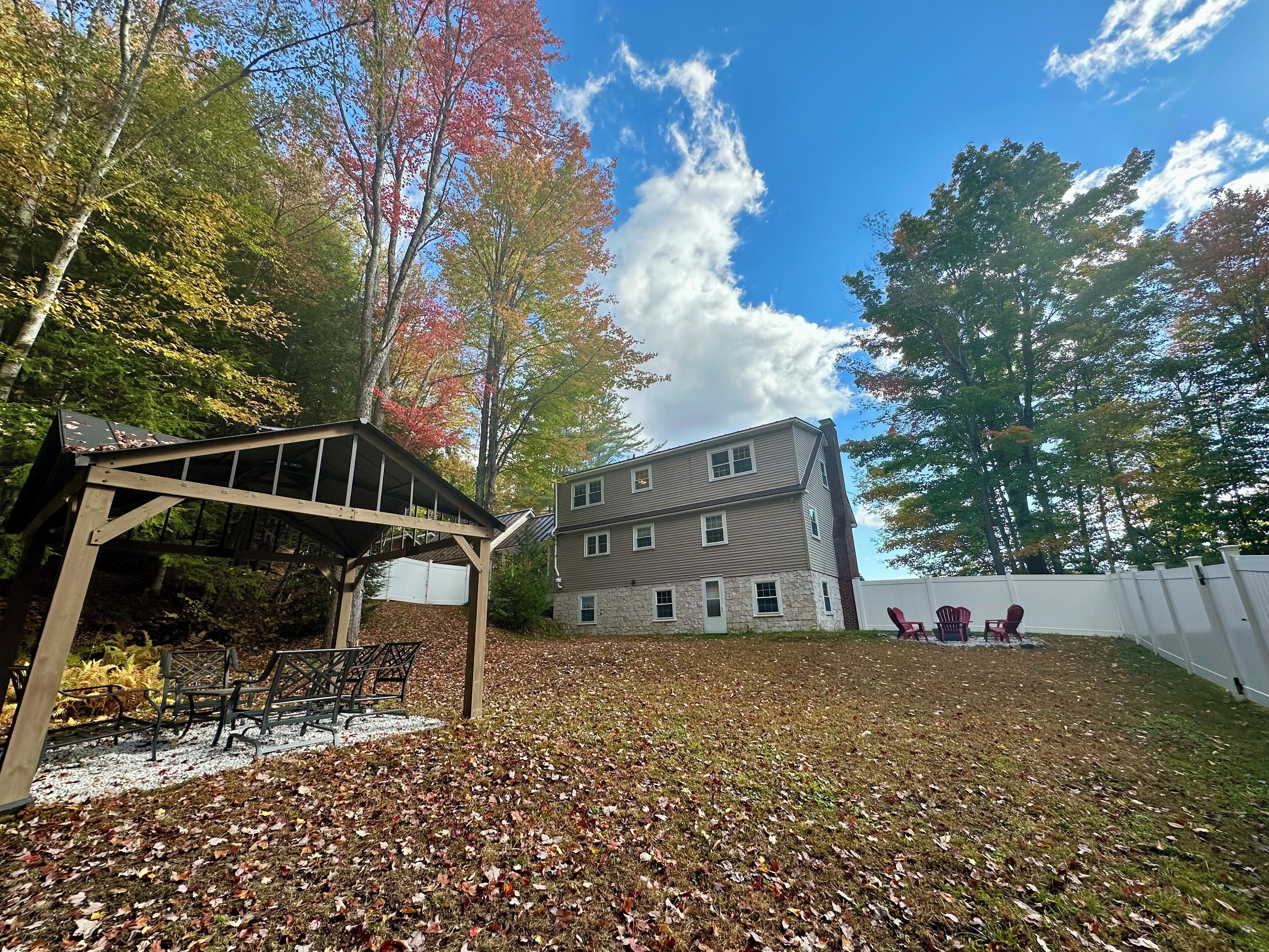 A two-story building with a covered patio area and outdoor seating.