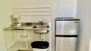 A compact kitchenette with a stainless steel refrigerator, a sink, and a coffee maker. - Fairway Courts Studio in Palmas del Mar- Great Pool, Just Mins to Hotel/Beach (Humacao)