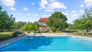 A rectangular swimming pool with a tiled edge, surrounded by a paved deck. - Cozy apartment in Lozovac with swimming pool (Lozovac)