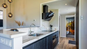 A modern kitchen with a large island, stainless steel appliances, and pendant lighting. - 2 bedroom amazing home in Voorthuizen (Voorthuizen)