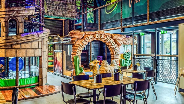 A restaurant with a rustic archway, seating area, and a view of the cityscape. - 2 bedroom amazing home in Voorthuizen (Voorthuizen)