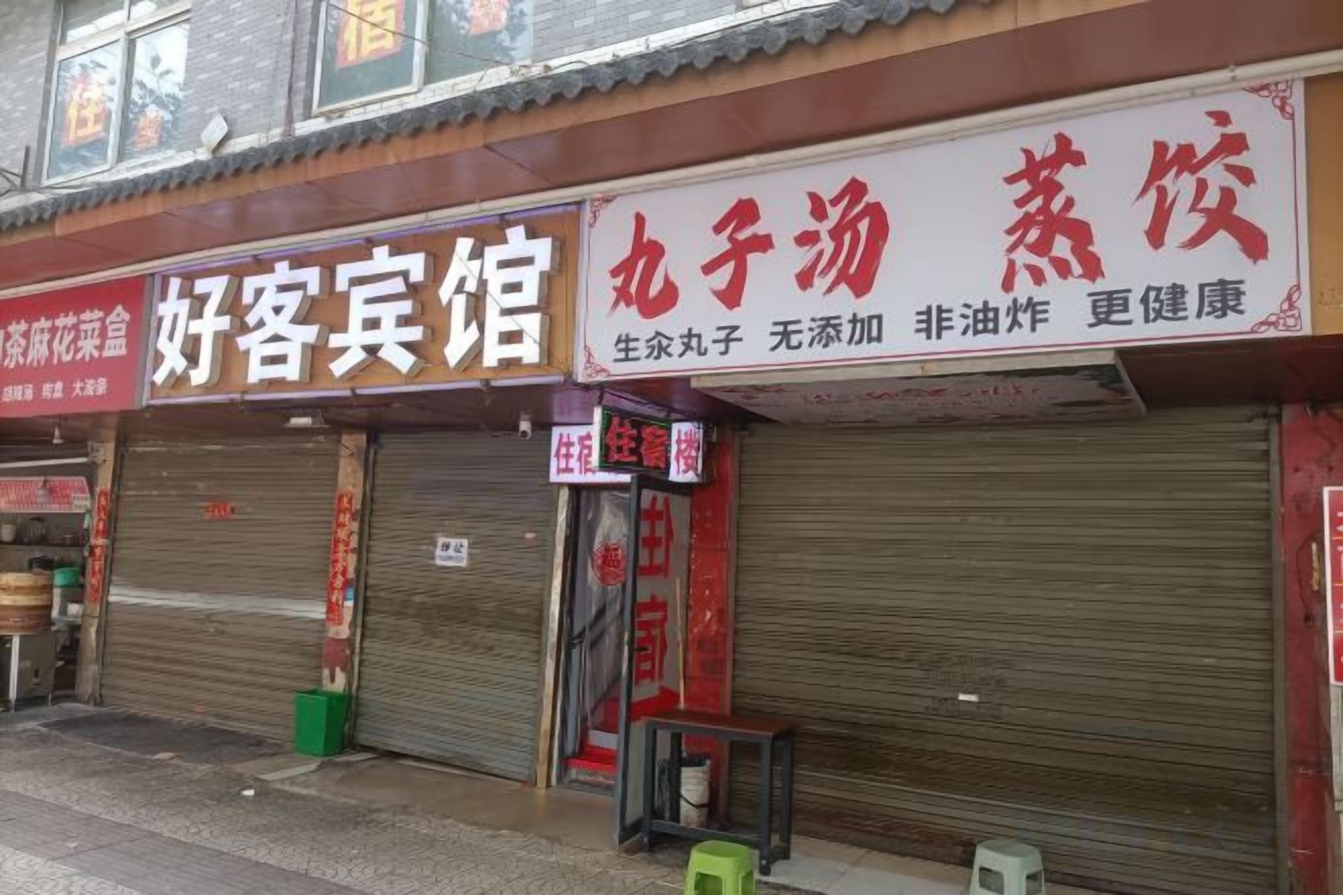 A row of closed storefronts with signage in a foreign language.