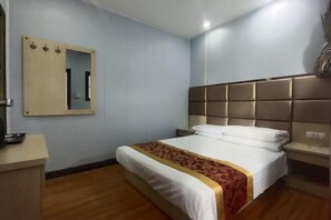 A hotel room with a bed, a bedside table, a mirror, and a wall-mounted light fixture. - Xi'an Lianhu District Hospitality Hotel (Xi'an)