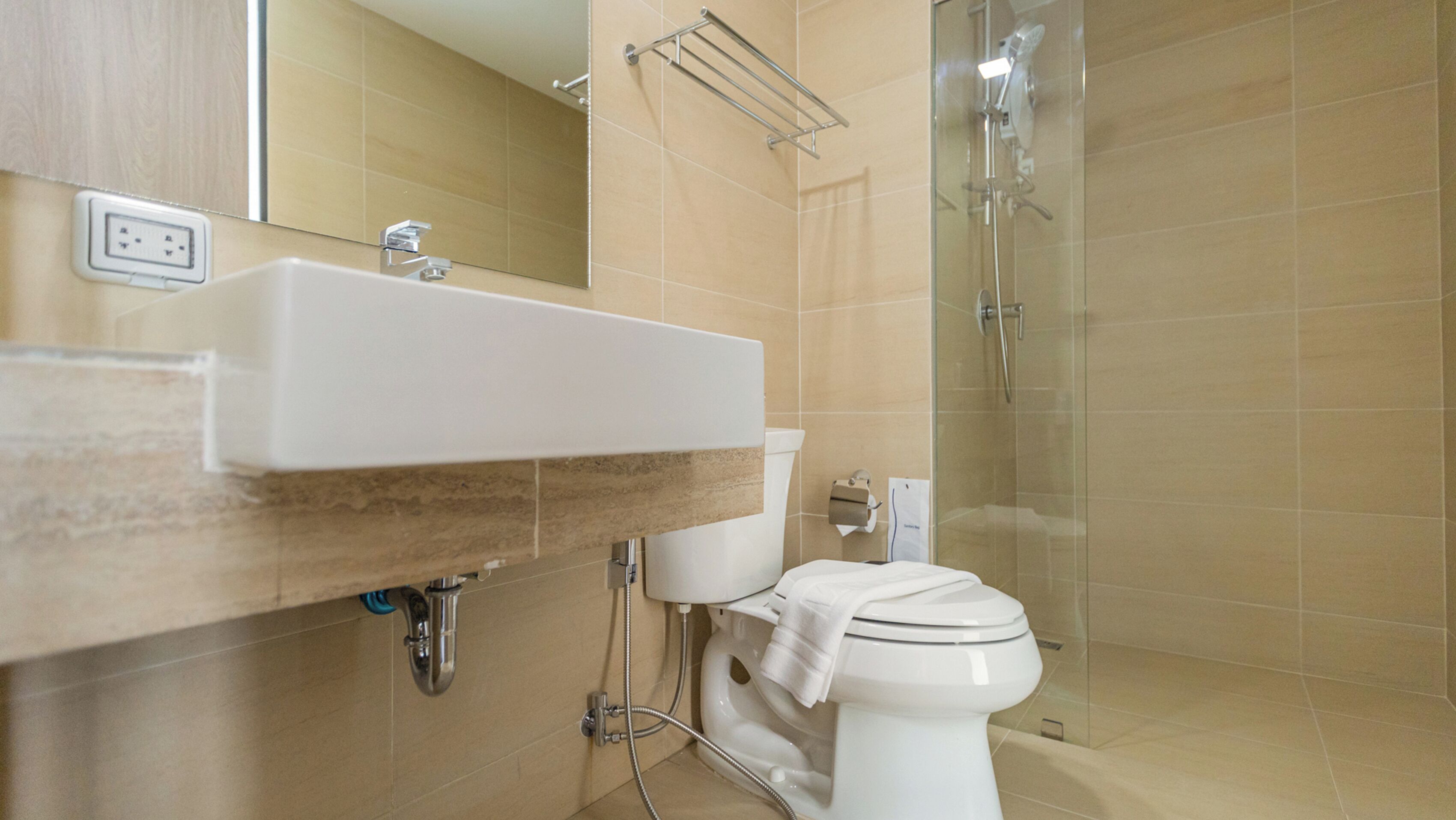 A bathroom with a sink, toilet, and shower.