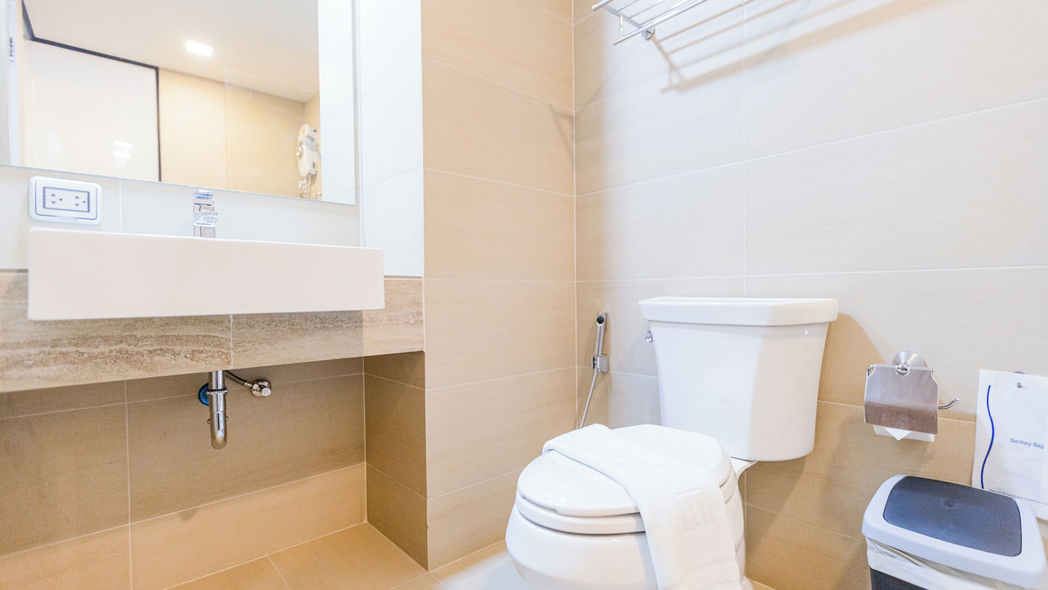 A bathroom with a toilet, sink, and shower.