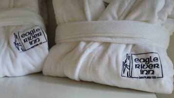 Neatly folded white towels with embroidered logos of Eagle River Inn and Minturn Co.