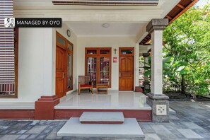 Welcome to OYO, where guests can enter through the beautifully maintained entrance, flanked by comfortable benches.