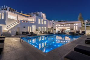 A modern hotel with a swimming pool, outdoor seating, and a bar area. - Rochari  (Mykonos)