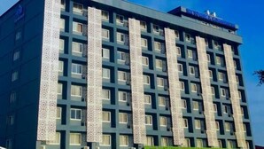 A multi-story hotel with a modern design, featuring a patterned facade and a flat roof. - SM Tower Hotel & Convention Center Berau (Tanjung Redeb)