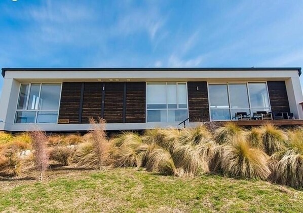 A modern building with large windows and a flat roof. - Explore Tekapo Accommodation (Lake Tekapo)